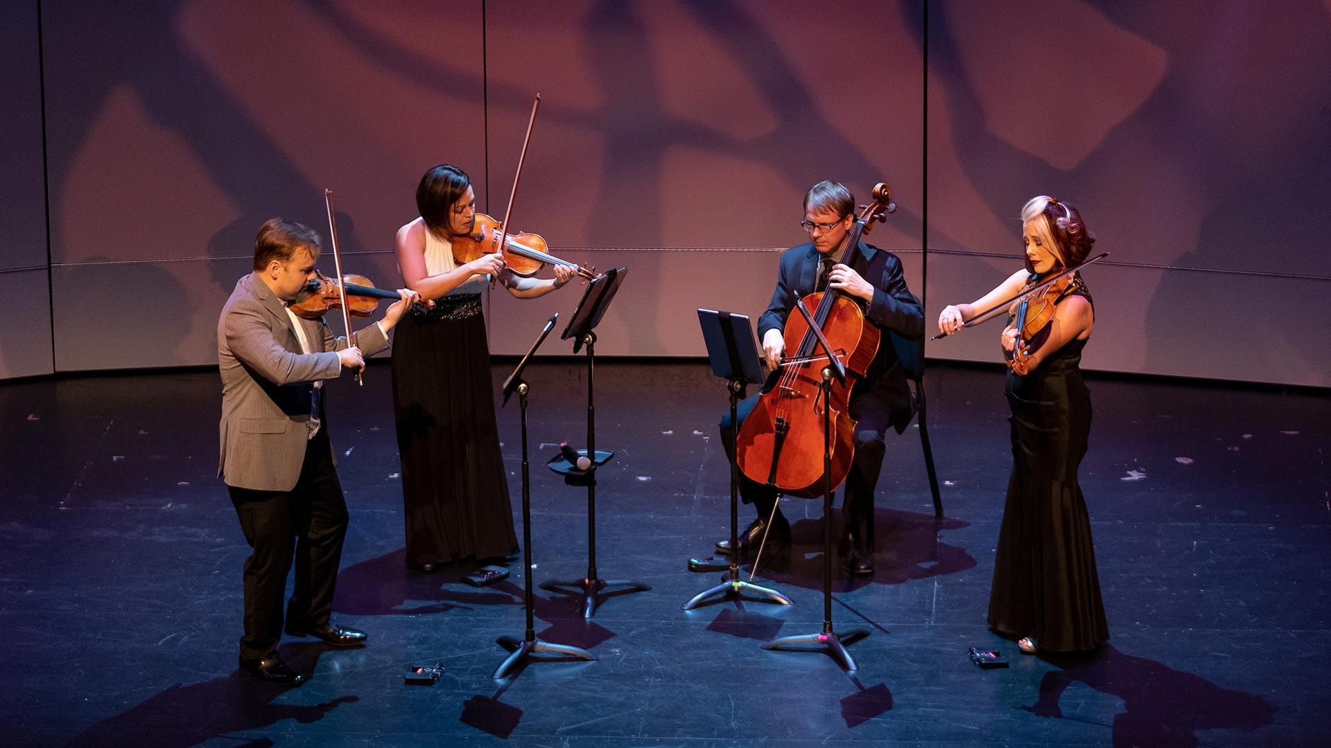 String musicians play on the stage at Bayou Theater