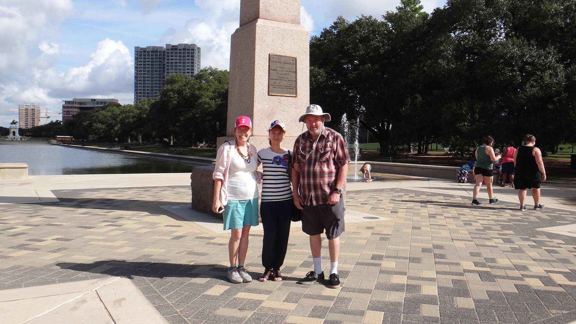 Three smiling people pose for a photo together in Houston.