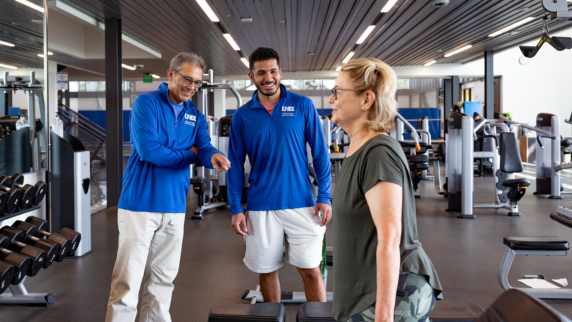 Dr. Joe Hazzard and Luis Gonzalez observe Sandra Salars' exercise in the UHCL Recreation and Wellness Center
