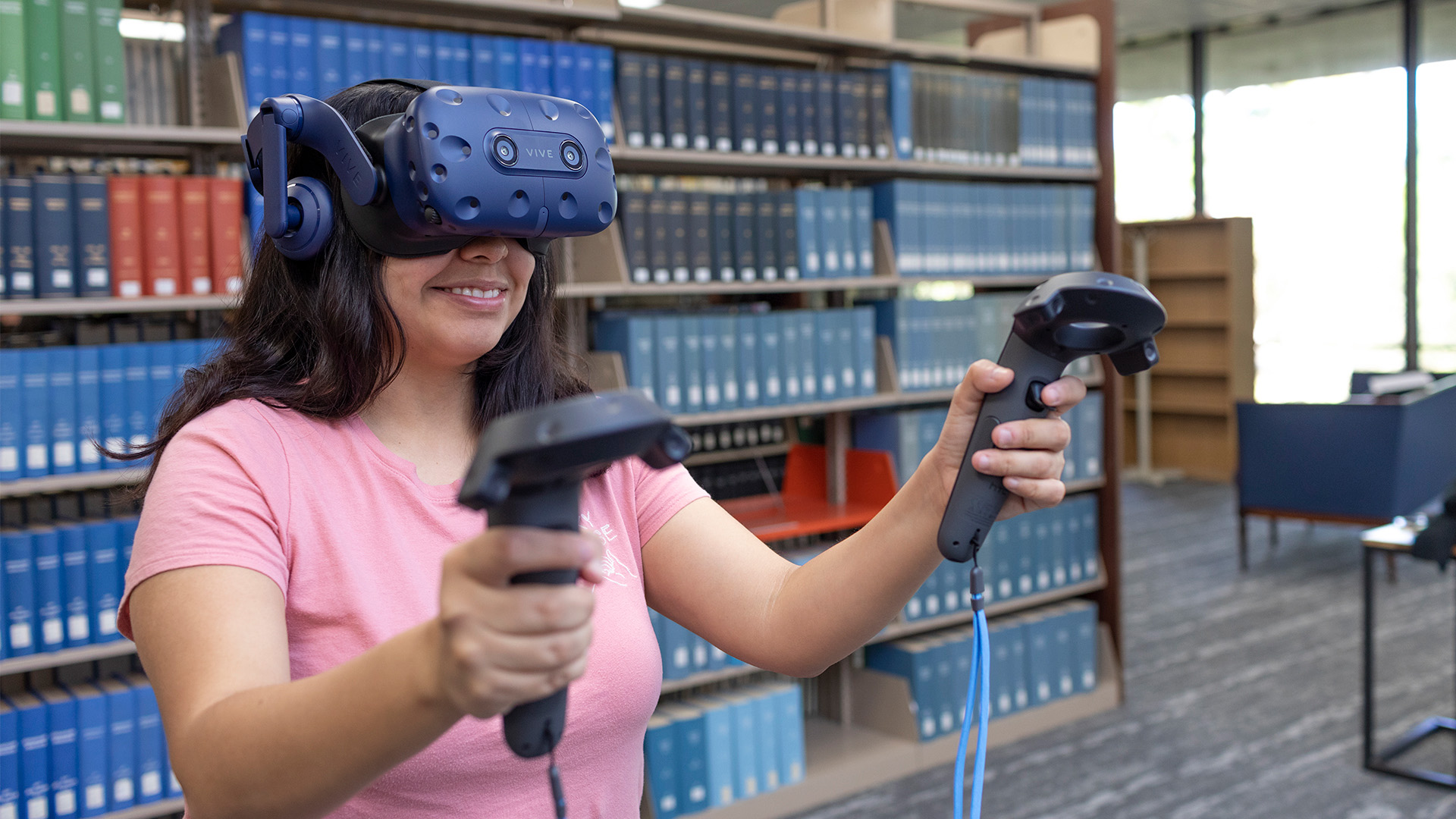 A student using a virtual reality headset in the library