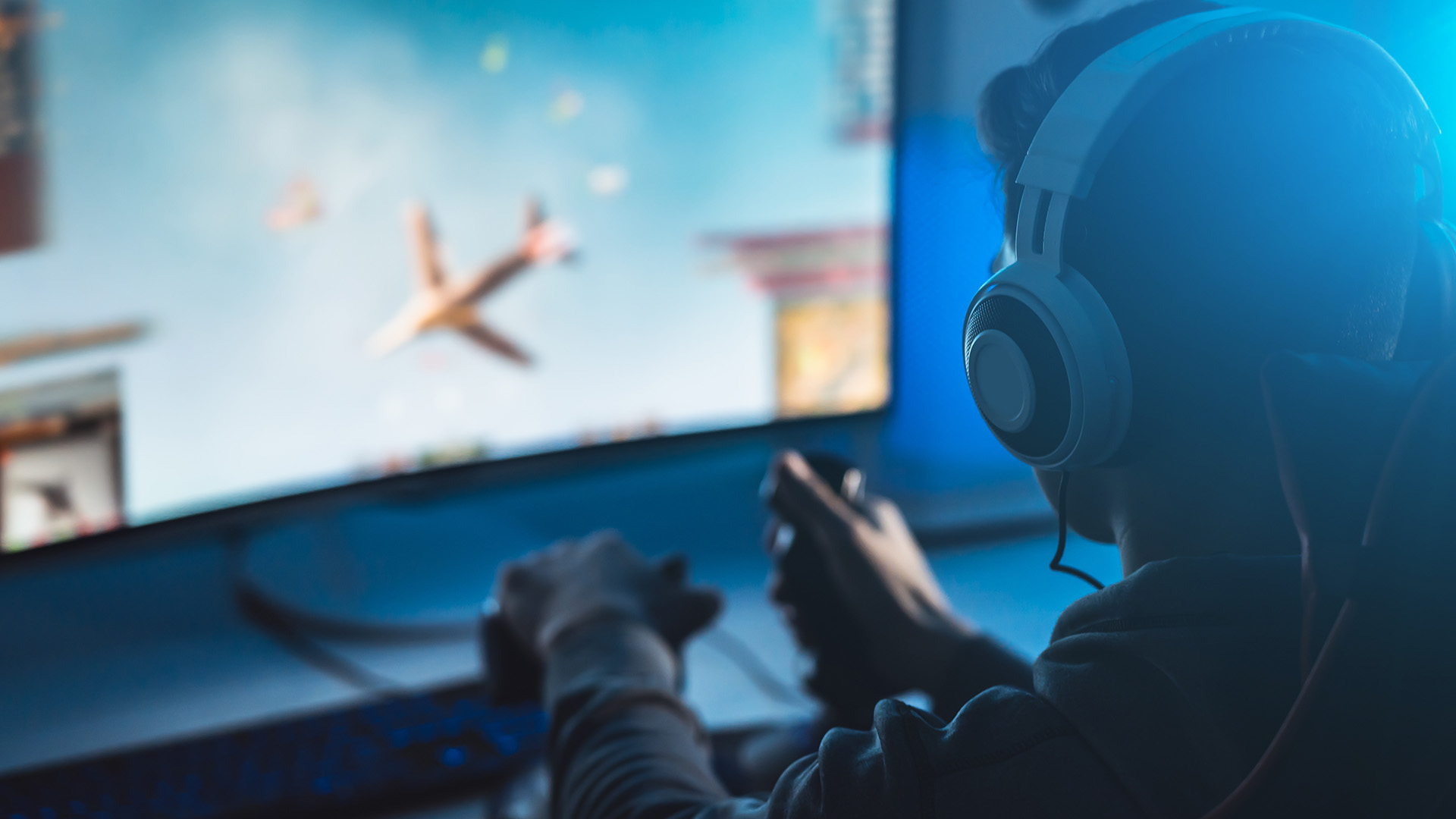 A person with headphones piloting a digital plane